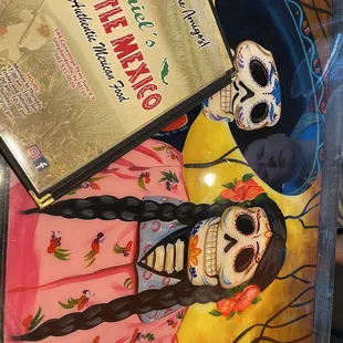 a girl in a pink dress and a skeleton