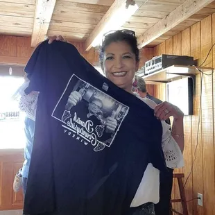 a woman holding a t - shirt