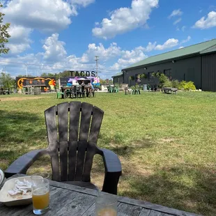 a picnic table with a plate of food and a glass of orange juice