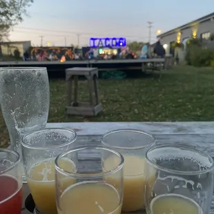 a row of glasses of orange juice