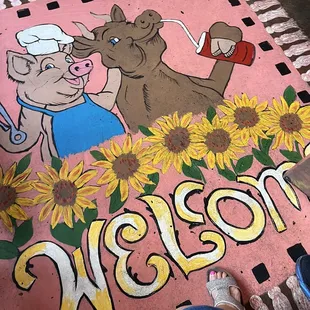 a pig and a cow with sunflowers