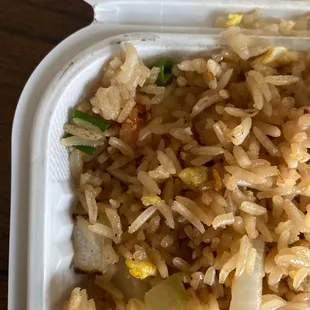 a container of rice and vegetables