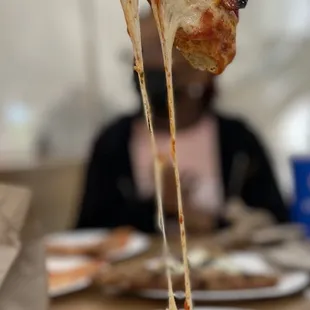 Check out the cheese pull in her!