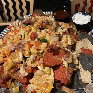 Chicken nachos with a nice house BBQ sauce and sour cream. Tons of plain chips buried in the middle.