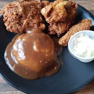 Chicken dinner with mashed potatoes and coleslaw
