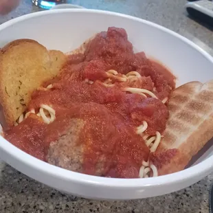 a bowl of spaghetti and bread