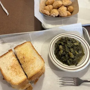 Chopped pork sandwich with collard greens and corn bites.