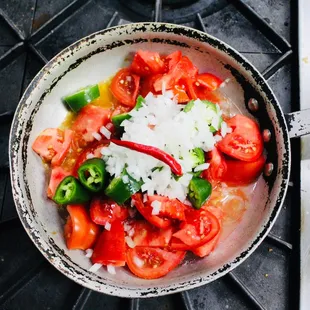 a bowl of tomatoes and peppers