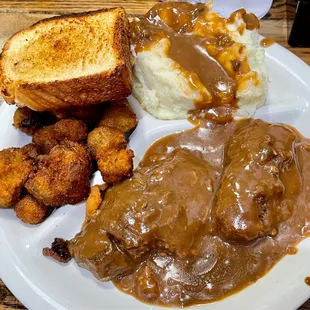 Country style steak, mashed potatoes with gravy, fried okra, and Texas toast.