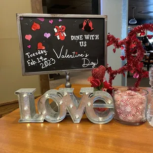 a love sign and vases of flowers
