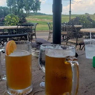 two glasses of beer on a table