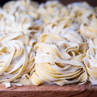 a wooden bowl filled with pasta