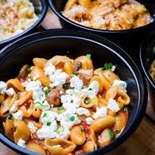 three bowls of pasta and cheese