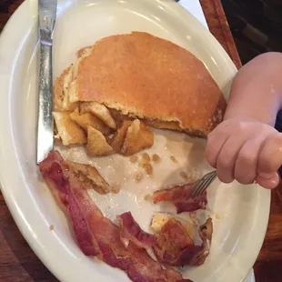 a plate of food with bacon and pancakes