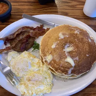 2 pancakes, 2 eggs, 2 pieces of bacon and 1 sausage patty. $9