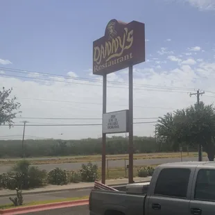 a truck parked in front of a restaurant