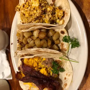 three breakfast tacos on a plate