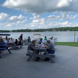 people sitting at picnic tables