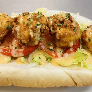 a chicken sandwich with lettuce, tomato, and cheese