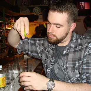 a man pouring a drink