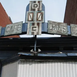 an old sign on the top of a building