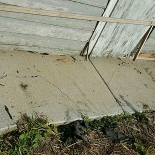 a broken door on the side of a building
