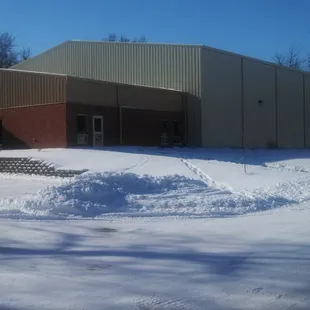 a snow pile in front of a building