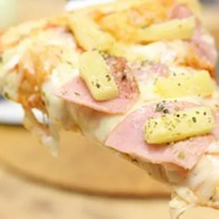 a slice of ham and pineapple pizza