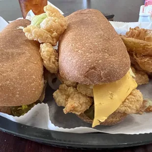 Shrimp poboy with cheese and side of onion rings