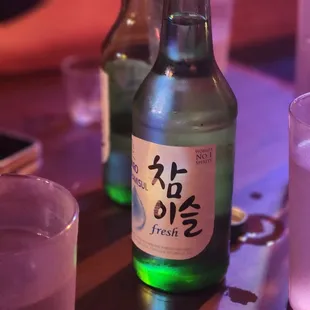 a bottle of sake and a glass of water