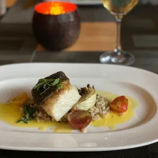 a plate of food and a glass of wine