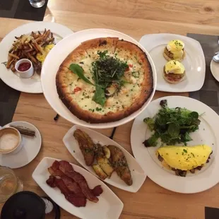 Lobster pizza. Mushroom omelette. Steak and eggs. Crab Benedict. Side of bacon and potatoes.