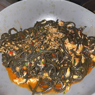 a plate of noodles with meat and sauce