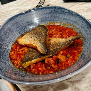 a plate of food with fish and beans