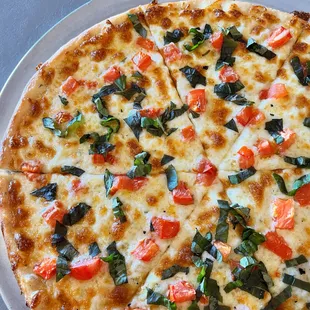 a pizza with tomatoes and basil
