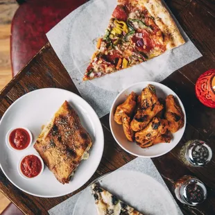 a table with pizza and fries