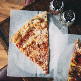 two slices of pizza on a table