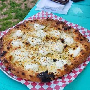 a pizza on a picnic table