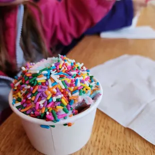 a girl taking a picture of a sprinkle