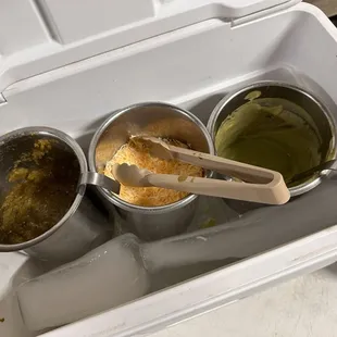 three different sauces in a cooler