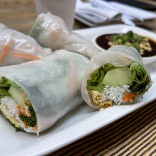 a plate of rice rolls and dipping sauce