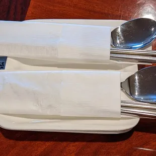 three spoons and a napkin on a table
