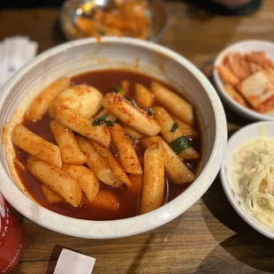 a bowl of soup and bowls of food on a table