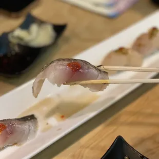 a close up of a sushi with chopsticks