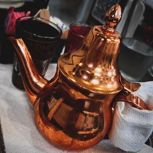 a copper teapot on a table