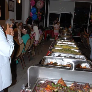 a buffet of food being served at a party