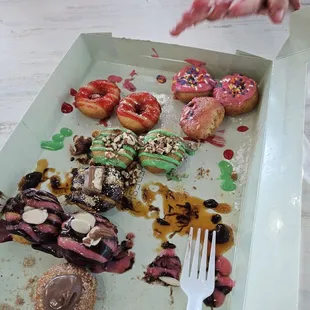 Little hands reaching towards the doughnuts