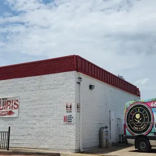 a delivery truck parked in front of a restaurant