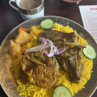 Lamb mandi and Adani tea with spicy sauce in background