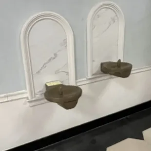 three urinals on the wall